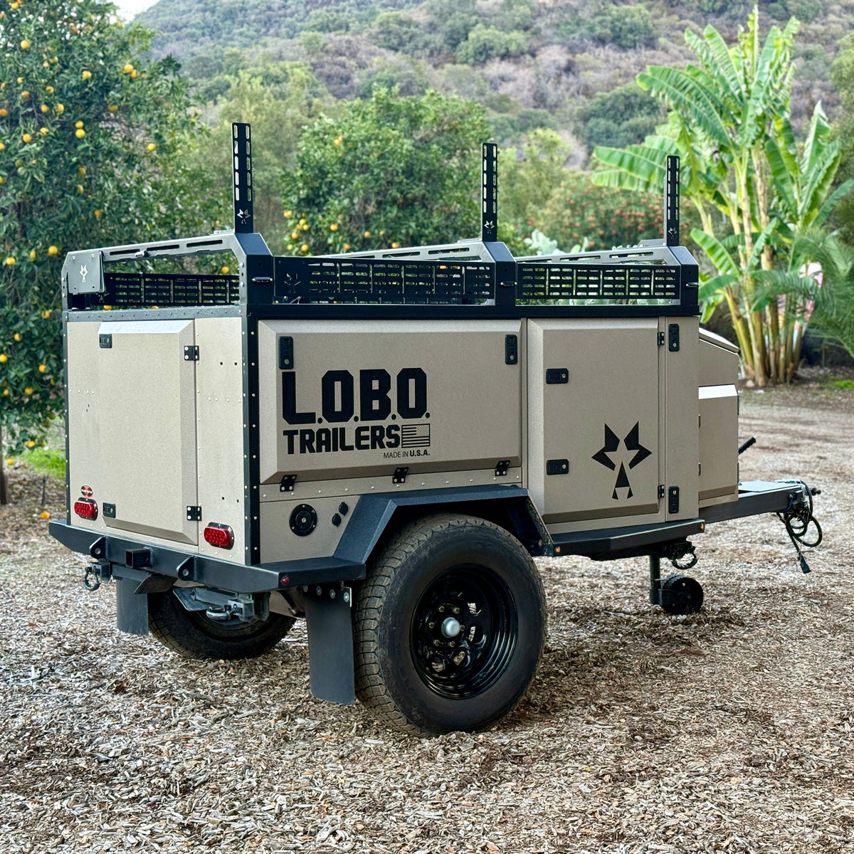 L.O.B.O. Alpha off-road camper trailer parked on a dirt lot, rear three-quarter view